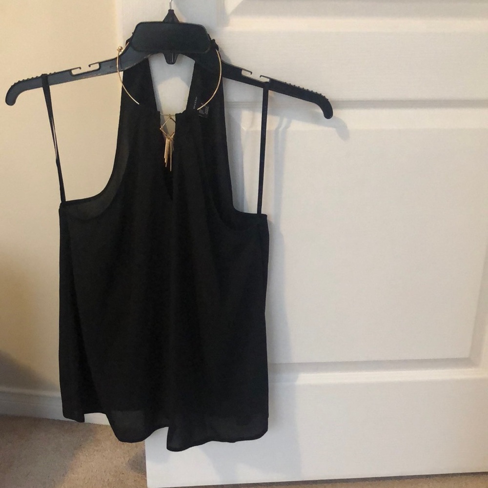 Cute little black top with gold necklace as part of the top